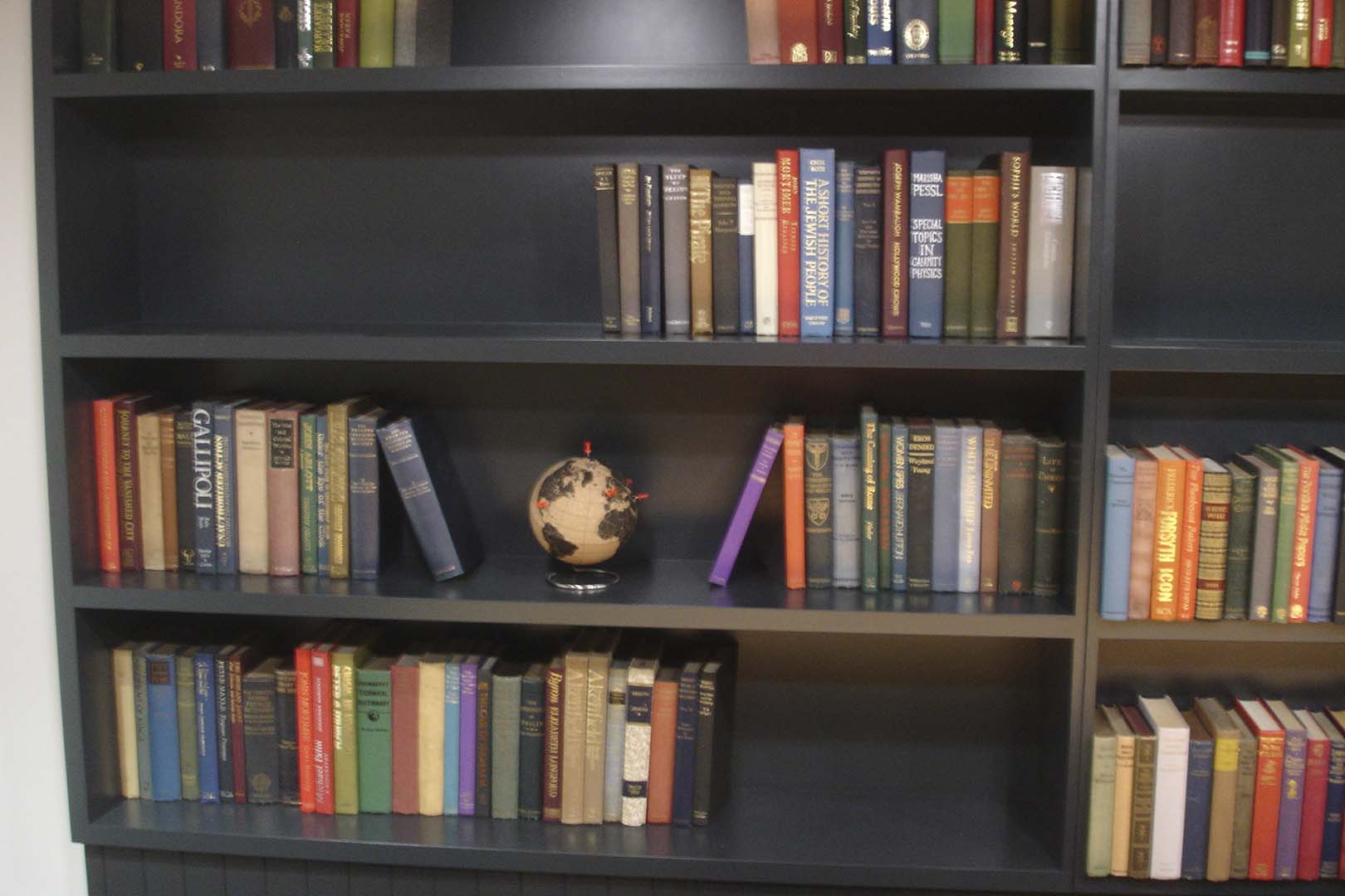Modern vintage books styled on office and reception shelving